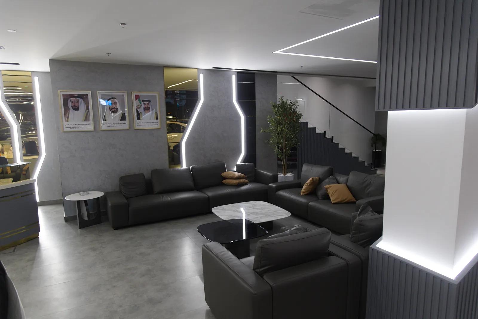 The customer lounge at Al Weam, lit by angular profiles set into the wall panels and a lit cove above the seating
