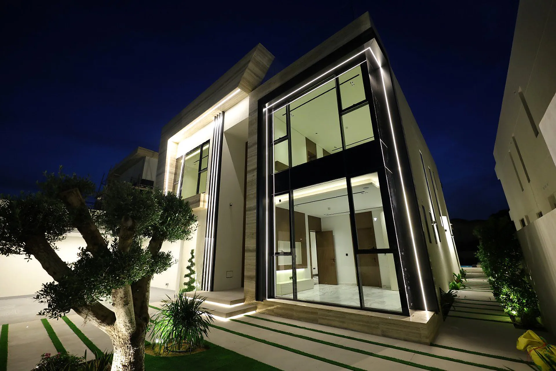 Night view of a private villa facade in Dubai lit by concealed linear fittings