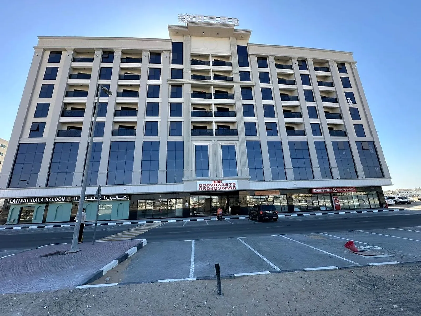 The Asak Building by day, showing the repeated pier-and-bay elevation the lighting picks out after dark