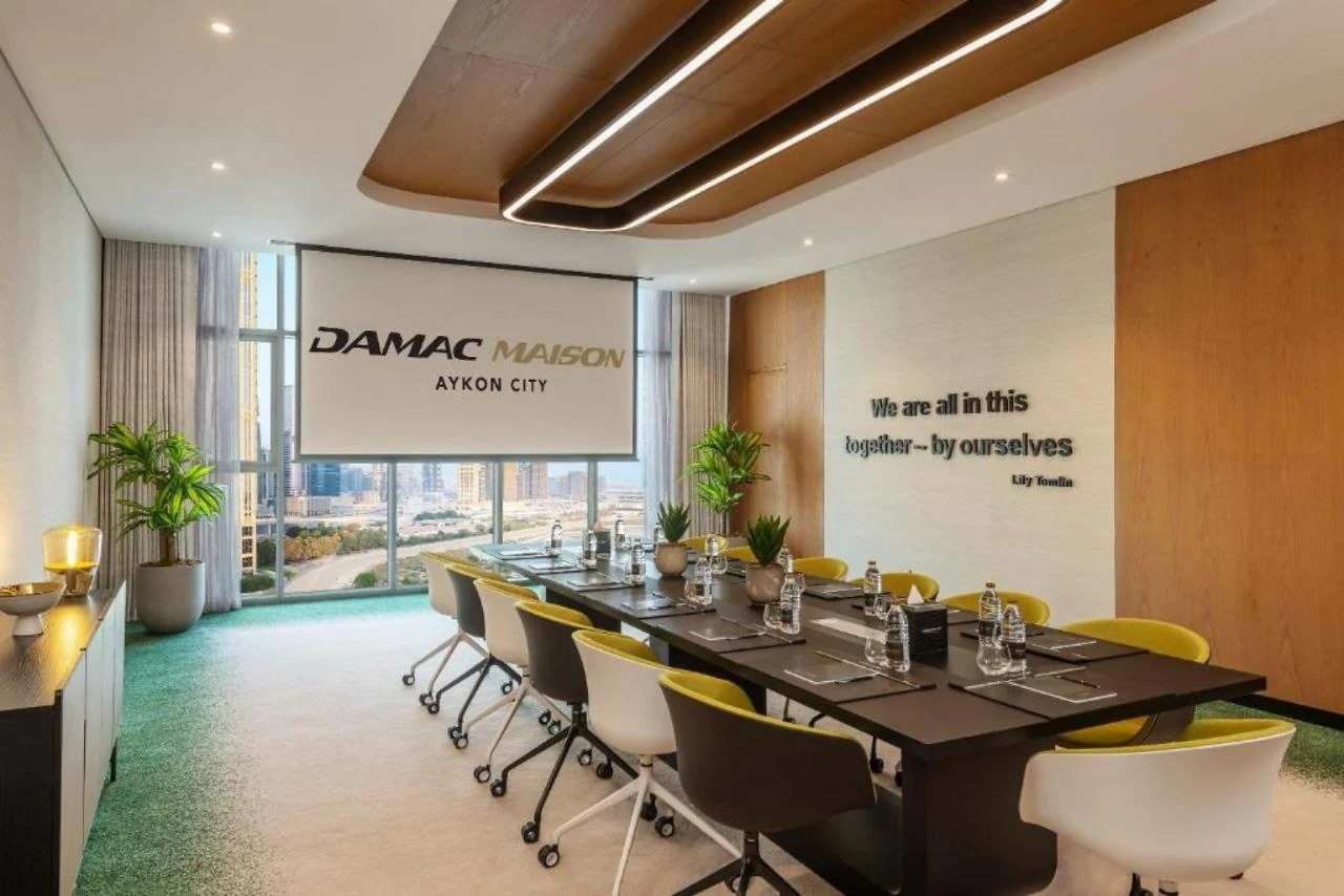 A meeting room at Aykon City with a linear run set into a timber ceiling coffer
