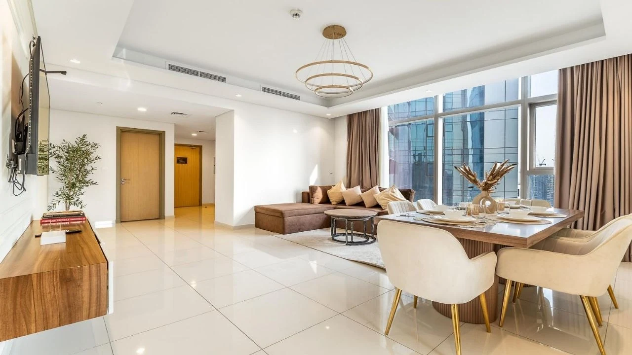 A serviced residence at Paramount Tower with a ring pendant over the dining table and downlights in a plaster ceiling