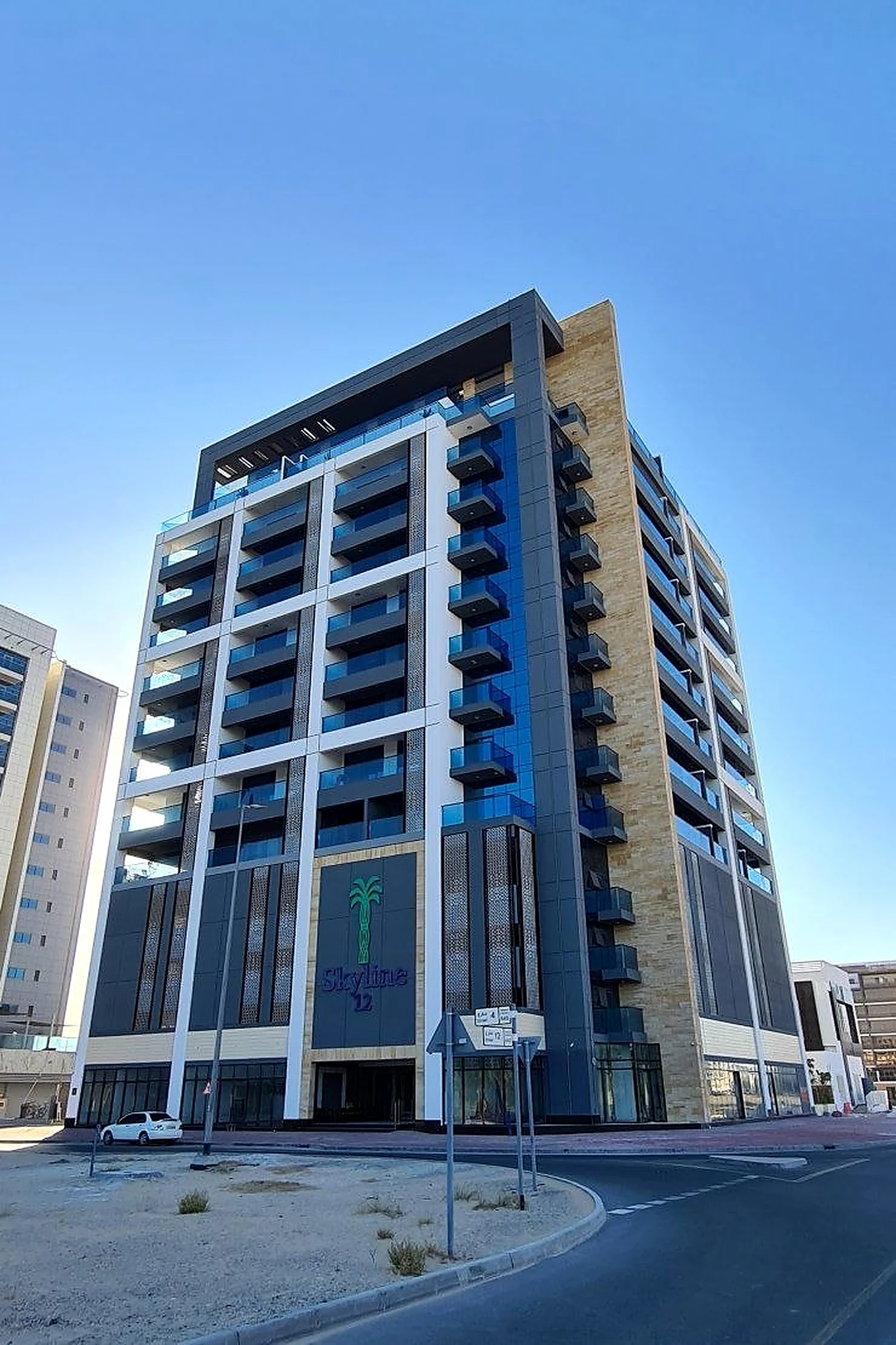 Skyline Building by day, its dark cladding and pale central pier reading as flat surfaces